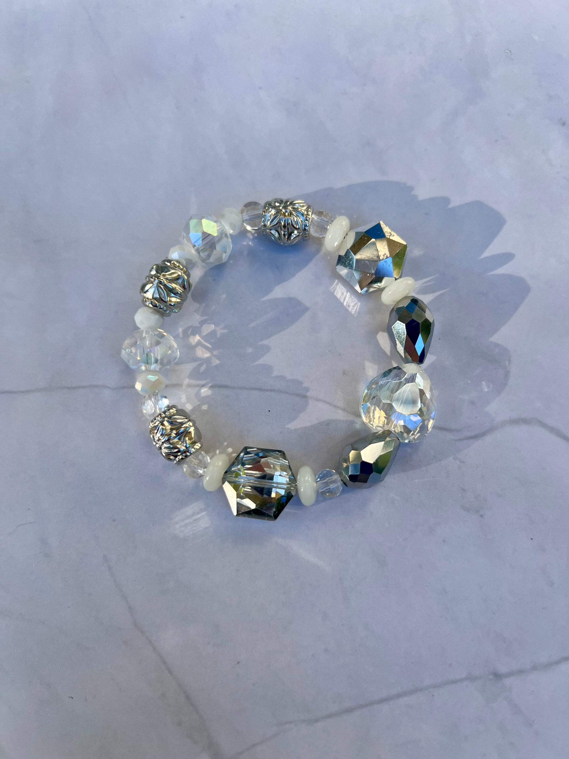 a bracelet made of glass beads on a marble surface