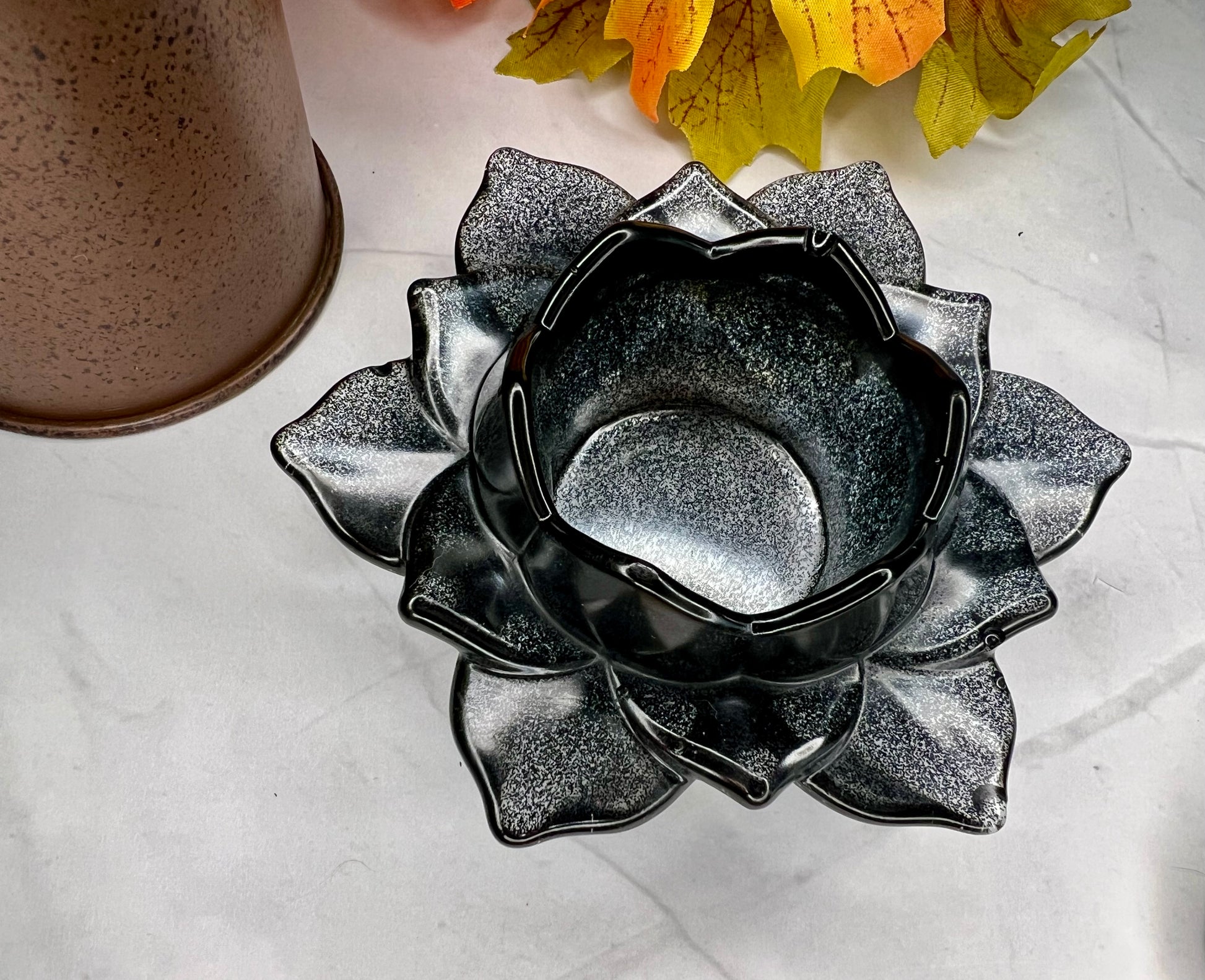 a black and white flower sitting on top of a table