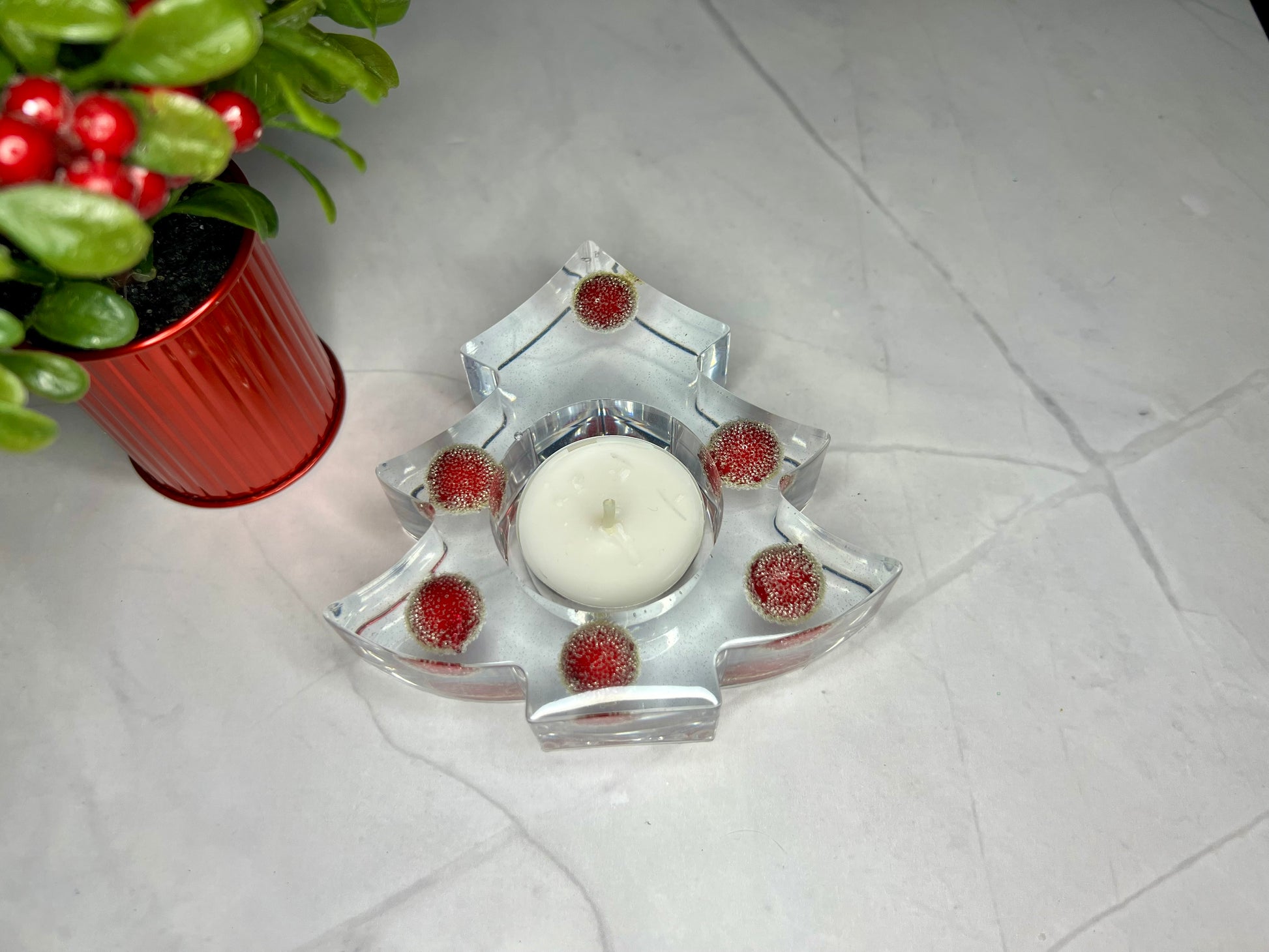 a glass candle holder with a candle inside of it