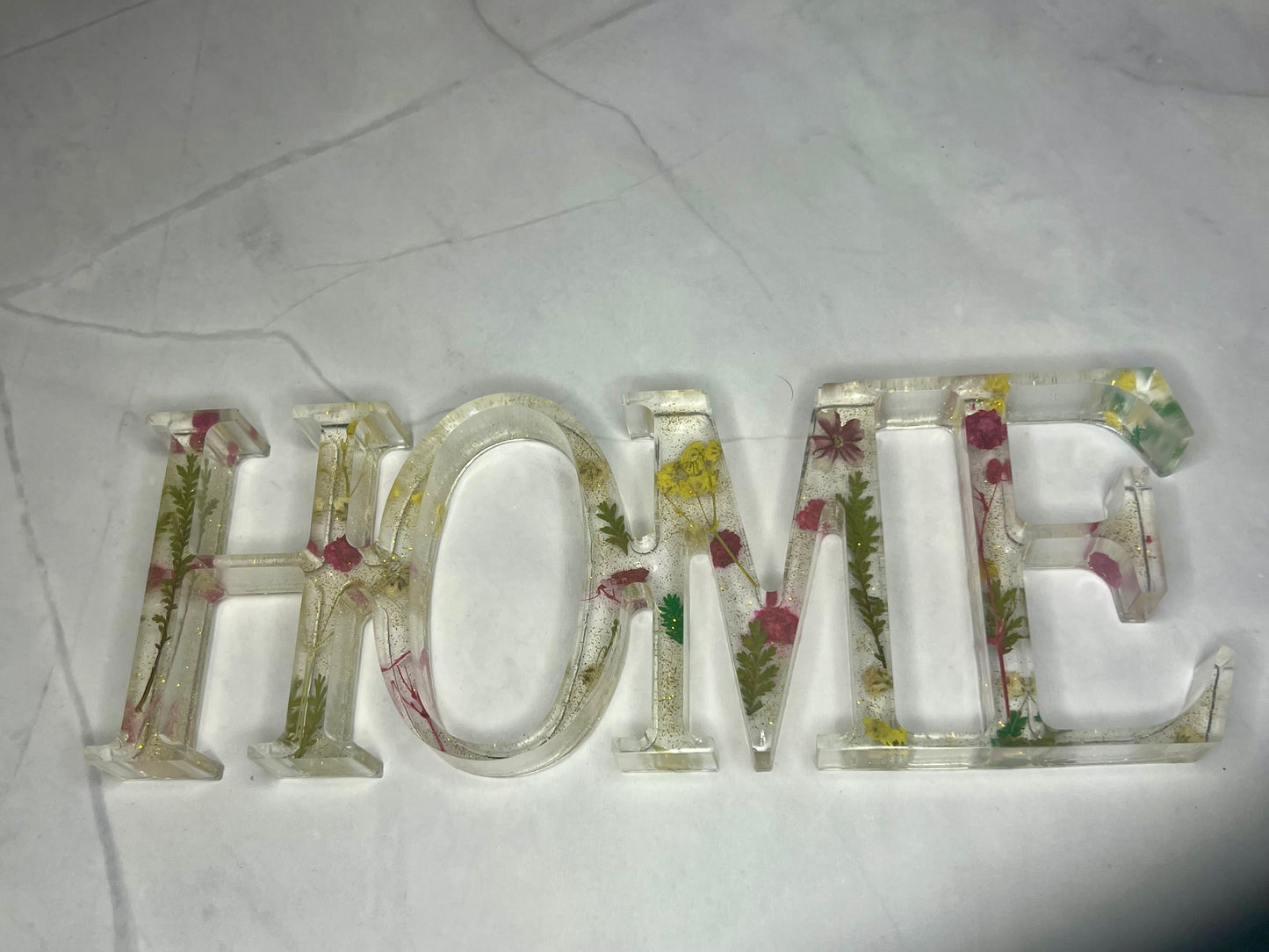 the word home spelled out of glass letters