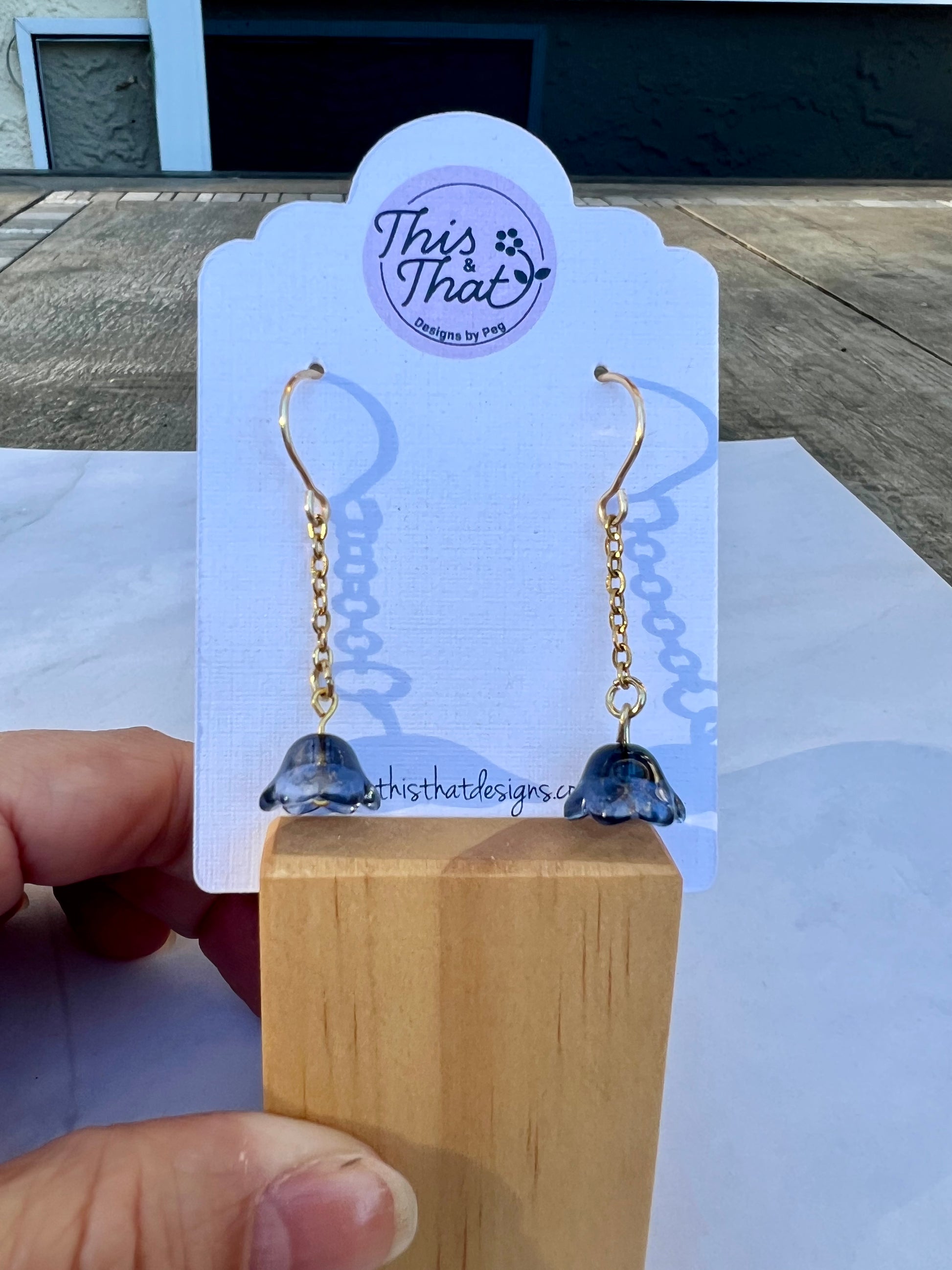 a pair of earrings is being held up