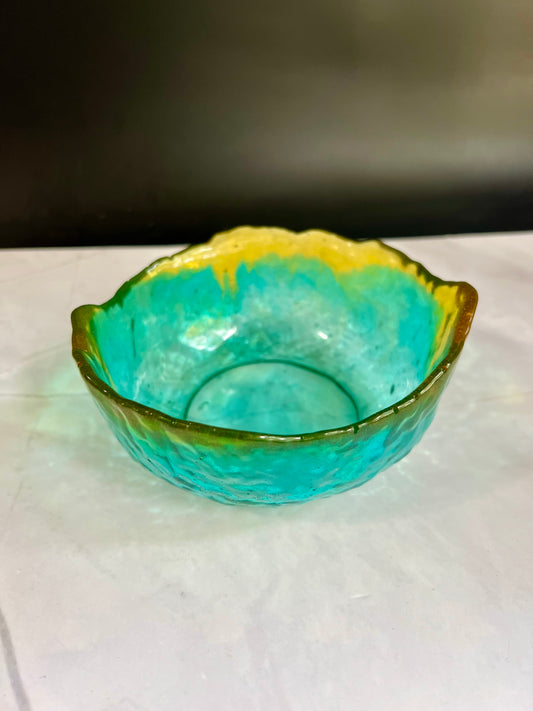 a glass bowl sitting on top of a table