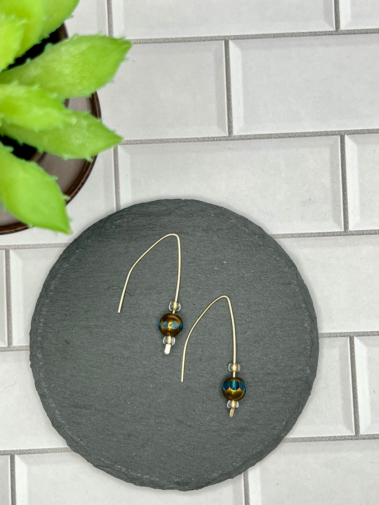 a pair of earrings sitting on top of a table