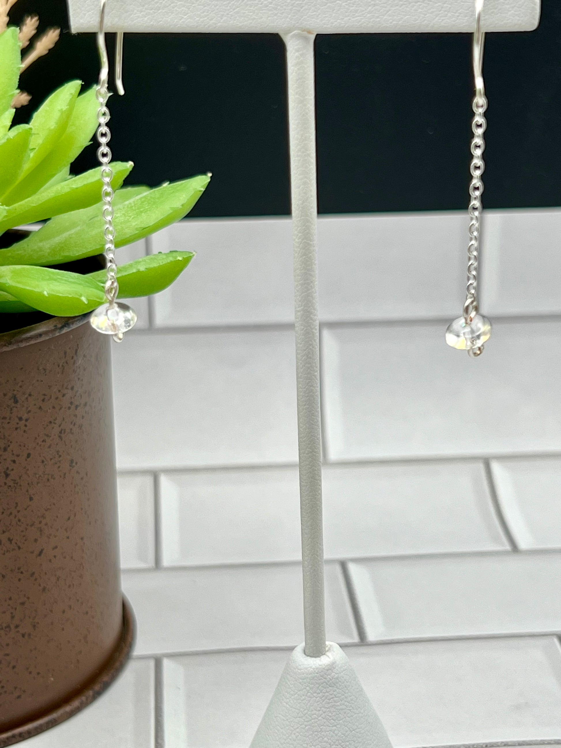 a pair of earrings hanging from a hook