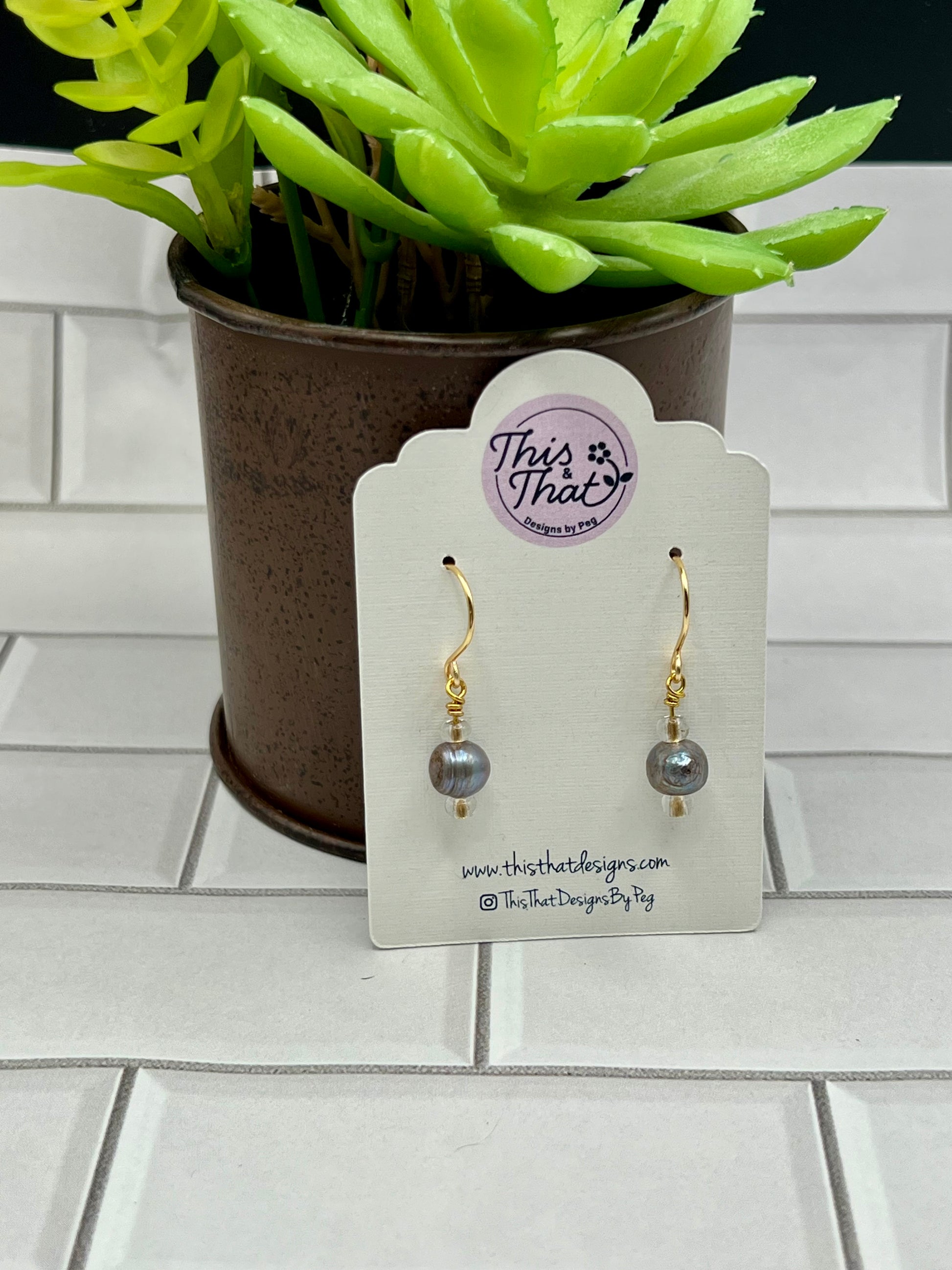 a pair of earrings sitting on top of a table